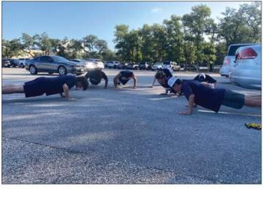 The drumline does pushups during water breaks. The Champion High School marching band gets water breaks every 10 minutes during their outdoor rehearsals. Photo by Xochilt Garcia.