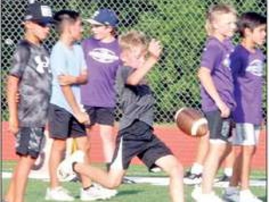 The youngsters sharpen their punting skills at the camp.