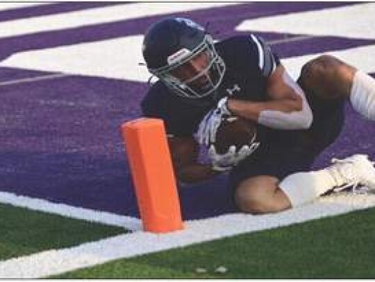 Champion’s Sawyer Bolli (15) hauls in a touchdown pass near the sideline during Friday’s contest against Eagle Pass. </br> Star photo by Chris Tilton