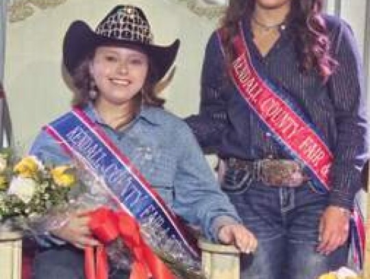 Hailey Johndrow takes her seat as the 2023-24 Ken-dall County Fair Association queen. Beside her is out-going queen, Mayah Morrison.