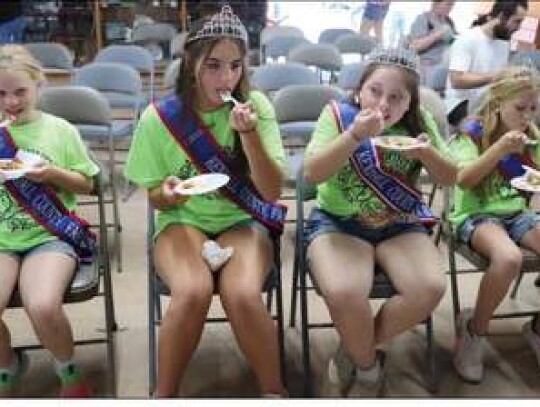 Members of the Kendall County Fair Association Queen’s Court take a taste of the apple pies entered in the fair contest. From left are Little Miss Raylee Resop, Princess Lila Morrison, Queen Hailey Johndrow, and Junior Miss Michaela Reichenau.